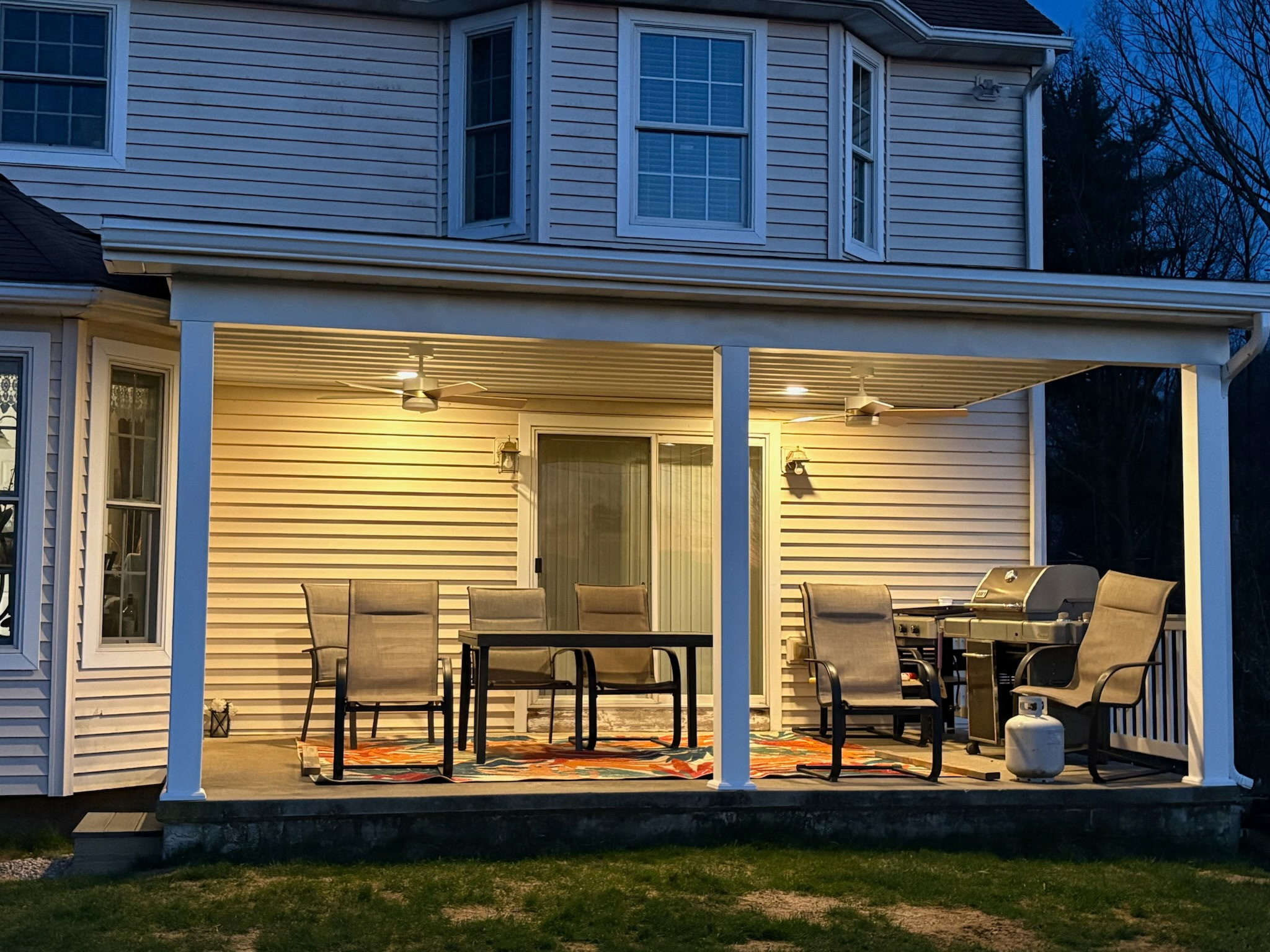 A new porch by Jared D. Aungst Construction lit up at night.